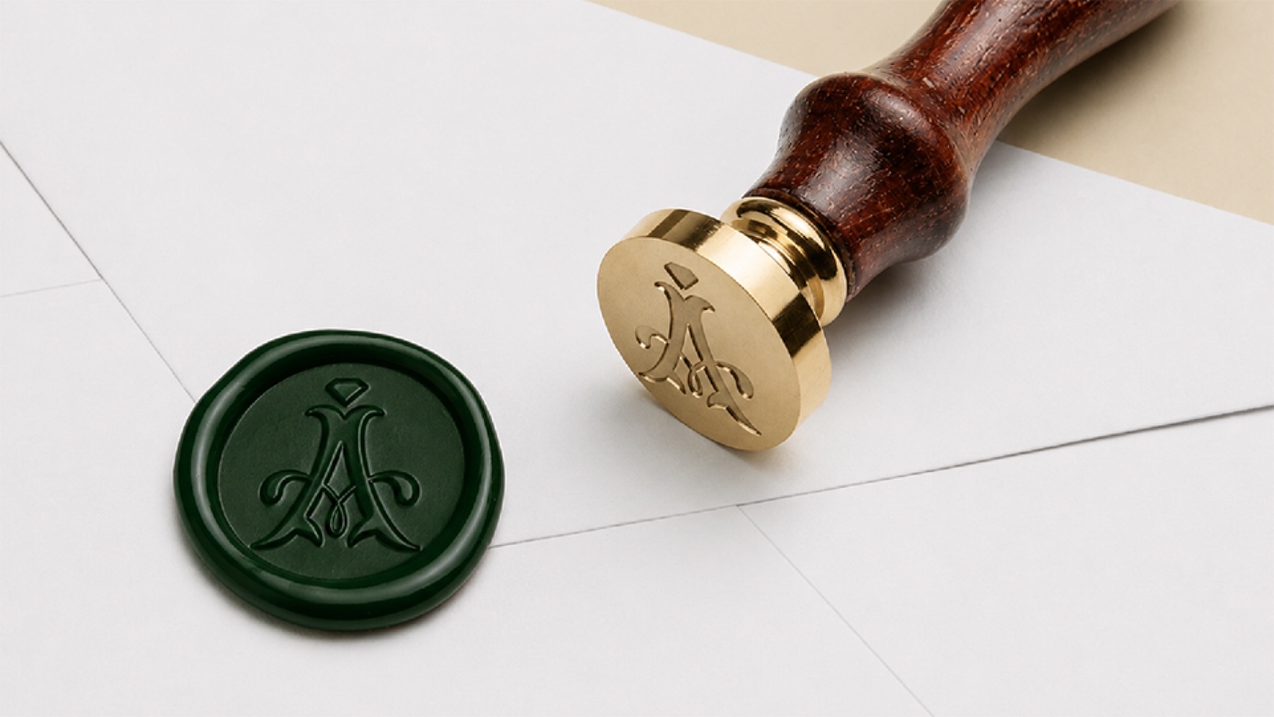 The Aureaux monogram pressed into a green wax seal